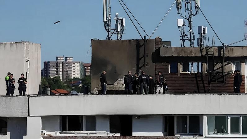Romanian law enforcement officers work on the site of an explosion at a residential block of flats following a drone hit close to the border with Ukraine, in Galati, Romania