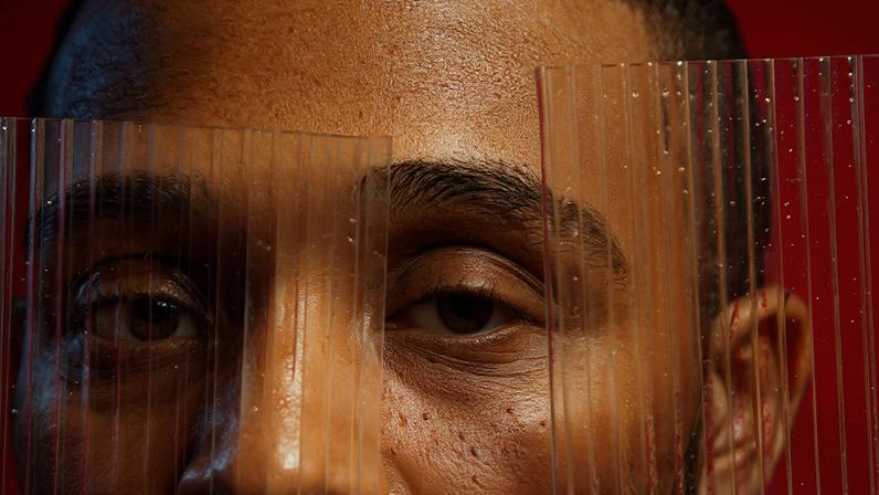 portrait of Jason Parham's face partially covered by textured glass