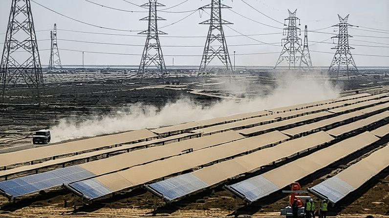 Workers install solar panels at the renewable energy park in Khavda controlled by the Adani Group.