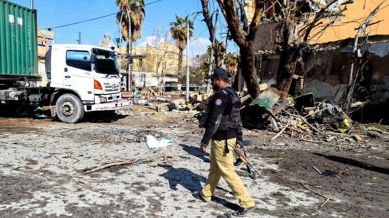 A police officer walks past damage at the site, after militant attacks, in Quetta, Pakistan, February 1, 2026. REUTERS/Stringer/File Photo