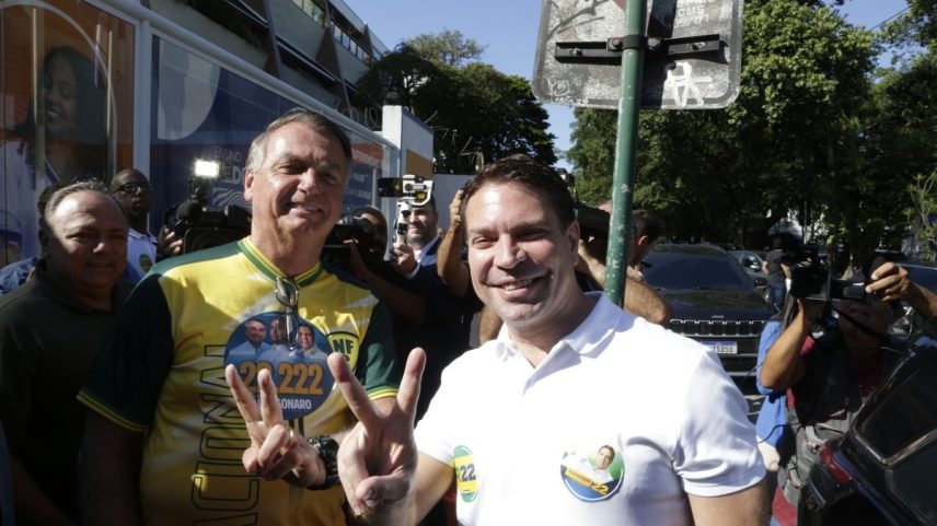 Alexandre Ramagem e o ex-presidente Jair Bolsonaro fazem o 'V' de vitória, após o candidato à Prefeitura do Rio votar na Barra da Tijuca (Foto: Domingos Peixoto/Agência O Globo)