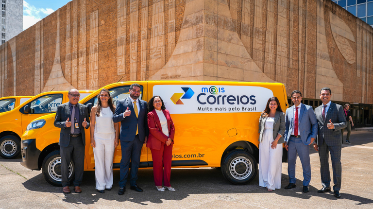Fabiano Silva, presidente dos Correios (de gravata amarela), posa com representantes da Infracommerce em frente a van com o logo do marketplace da estatal (Foto: Shizuo Alves/MCom/Divulgação)