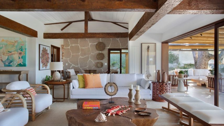SALA DE ESTAR | O ambiente é composto por sofás, mesa lateral (à esquerda), par de bancos e mesa de centro de tronco de árvore, todos da Breton. Abajur do Studio Grabowsky. Tapete da Trama (Foto: MCA Estúdio/Divulgação)