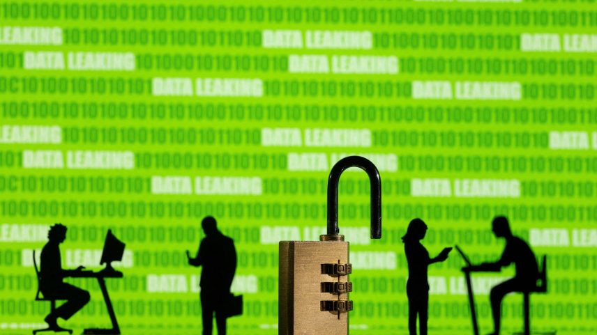 Silhuetas de bonecos em ambiente corporativo, à frente de códigos de programação e ao lado de um cadeado destrancado (Foto: Dado Ruvic/Reuters)