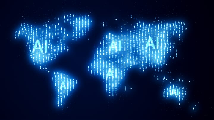 Ilustração digital de um mapa-múndi iluminado com o texto "IA" em vários continentes, representando a presença global e a integração da inteligência artificial. (Foto: Fotograzia | Moment | Getty Images)