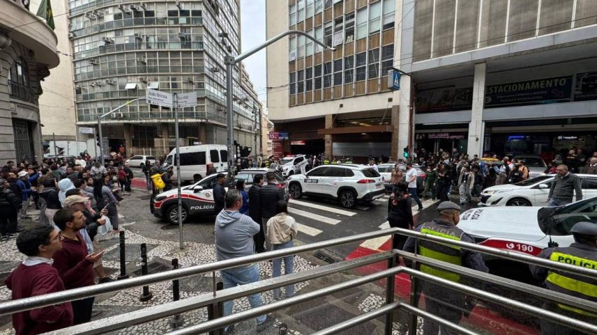 Curiosos observam movimentação da polícia na rua Boa Vista, no centro de São Paulo, onde uma mulher foi morta pelo ex-companheiro, que se matou em seguida na tarde desta sexta-feira (25) (Foto: Leitor)