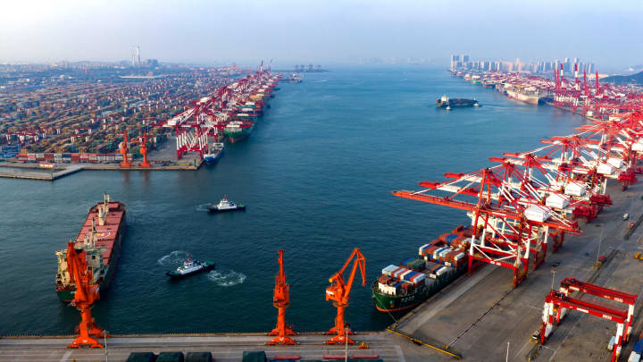 Um navio de carga carrega e descarrega contêineres no Terminal de Contêineres Qianwan do Porto de Qingdao, na cidade de Qingdao, província de Shandong, China, em 10 de julho de 2025. (Foto: Costfoto | Nurphoto | Getty Images)