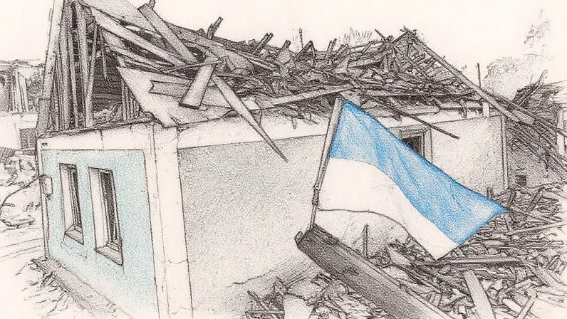 Uma bandeira da Ucrânia tremula ao lado de uma casa completamente destruída no conflito com a Rússia (Foto: Scott Olson/Getty Images)
