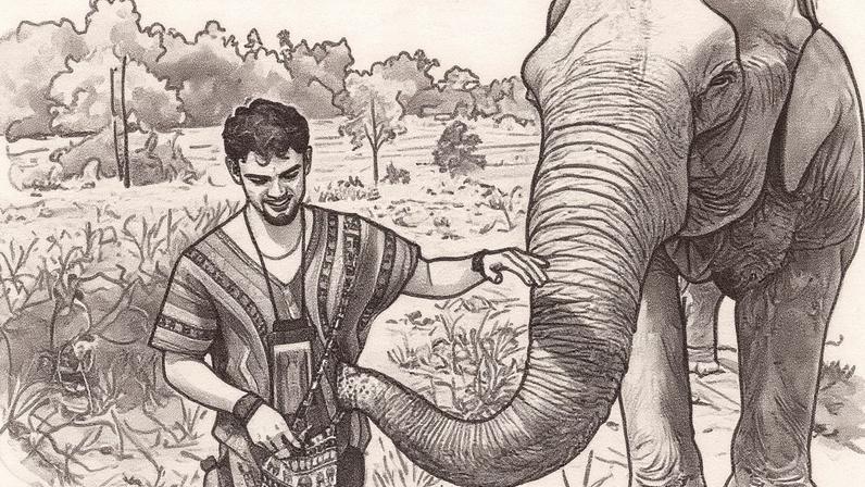 Calum Macdonald acaricia um elefante enquanto ele toca sua camisa de padrão listrado com a tromba. Atrás deles, há campos de arroz verdes e florestas tropicais além disso. Ele tem cabelo curto e cacheado. (Foto: Reprodução)