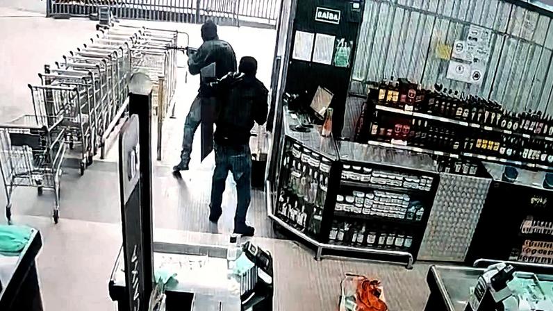 Criminosos armados com fuzis tentaram roubar um carro-forte em um mercado de Osasco (SP), mas a reação dos seguranças impediu a ação (Foto: Reprodução de vídeo)