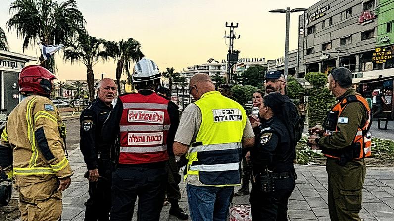 Israeli soldiers and emergency responders work at the scene of a drone attack from Yemen, in the southern Israeli resort city of Eilat.