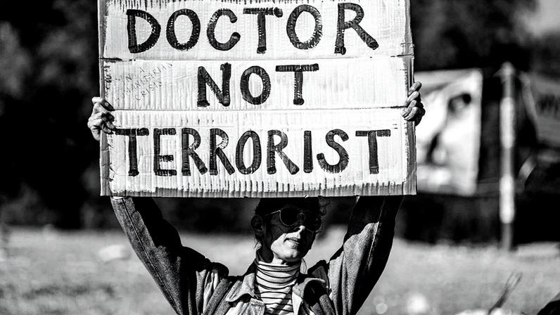 Protesto em frente à prisão de Sde Teiman, no deserto de Negev, com cartazes que dizem "Médico, não terrorista" (Foto: Reprodução)