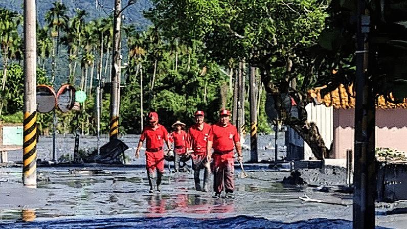 A rescue team looks for flood victims on Thursday after a barrier lake burst in Hualien, Taiwan. Photograph: I-Hwa Cheng/AFP/Getty Images