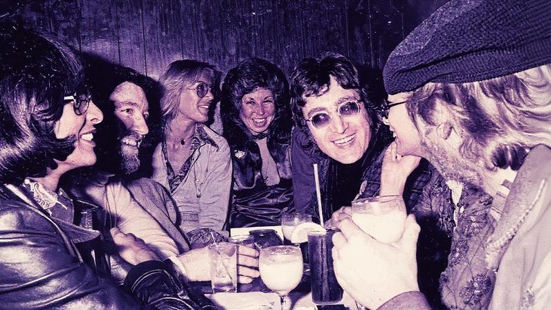 Singer-guitarist John Lennon (center right), formerly of The Beatles, attends a Smothers Brothers comedy performance with girlfriend May Pang and fellow singer-songwriter Harry Nilsson (far right), during Lennon's infamous 'Lost Weekend' period, at the Troubadour on March 12, 1974, in West Hollywood, California. Lennon and Nilsson would later be kicked out of the show for drunken heckling.