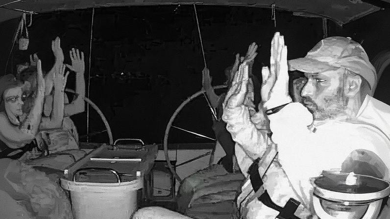 The crew of one of the Gaza-bound vessels with their hands up as they are boarded by Israeli military. Photograph: Global Sumud Flotilla/Reuters