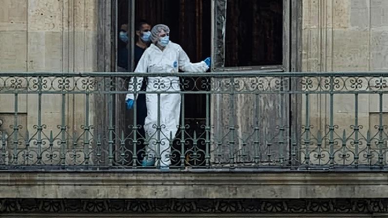 A forensics officer examines a cut window and balcony of a gallery at the Louvre. Photograph: Kiran Ridley/Getty Images