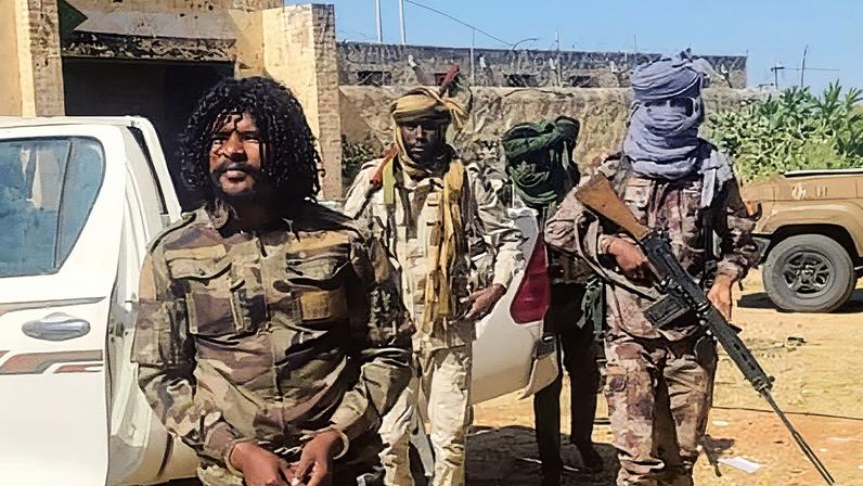 The Rapid Support Forces released a photo showing one of their own fighters known as Abu Lulu, left, being arrested in El Fasher. Photograph: Rapid Support Forces/AFP/Getty Images