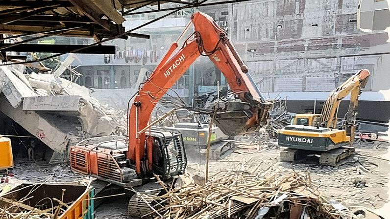 Rescuers use heavy machinery to clear the rubble during the search for victims at a building that collapsed at an Islamic boarding school in Sidoarjo, East Java, Indonesia.
