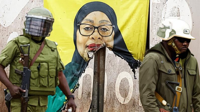 Tanzanian riot police officers walk past a vandalised campaign poster of President Samia Suluhu Hassan. Photograph: Thomas Mukoya/Reuters