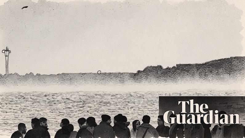 People hoping to get to the UK wait in the sea to board a small boat in Gravelines, France, on Wednesday.