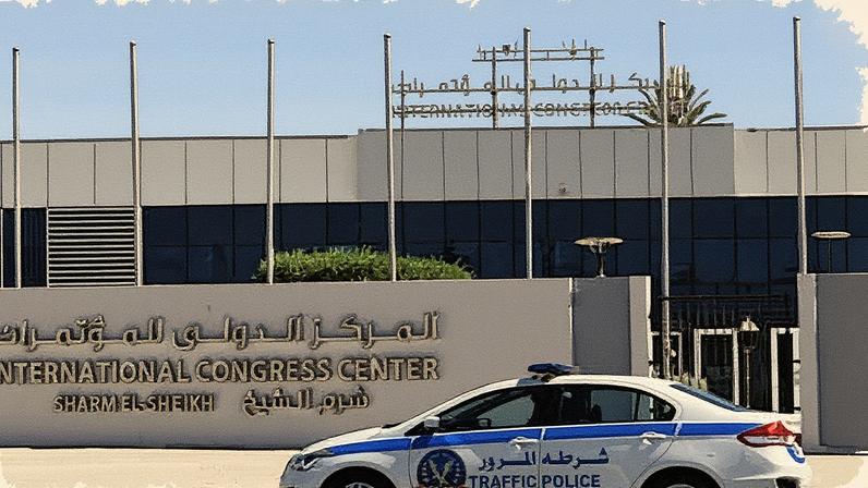 A police car is stationed in front of the International Congress Center in Sharm el-Seikh, as the Egyptian resort town gets ready to host a US-brokered Gaza peace summit