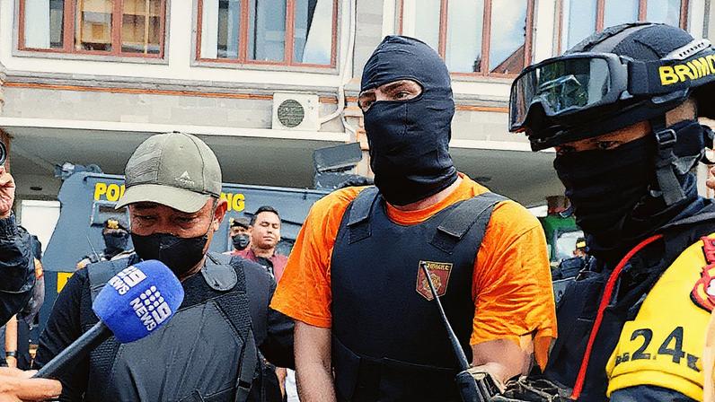 Australian national Darcy Francesco Jenson is escorted as he is handed over to prosecutors at the prosecutor’s office in Badung, Bali, Indonesia, 15 October 2025.