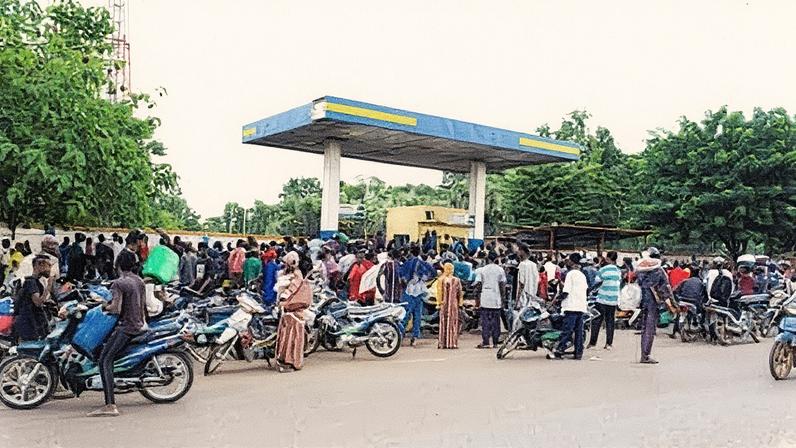 People gather at a petrol station in Bamako, Mali, due to fuel shortages. Photograph: Idriss Sangare/Reuters