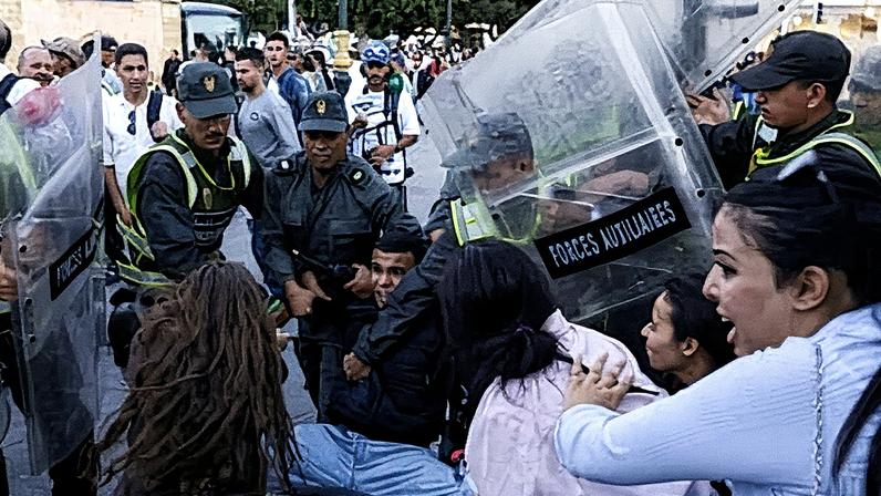 Police arrest a young man during clashes in Rabat, Morocco. Photograph: Abdel Majid Bziouat/AFP/Getty Images