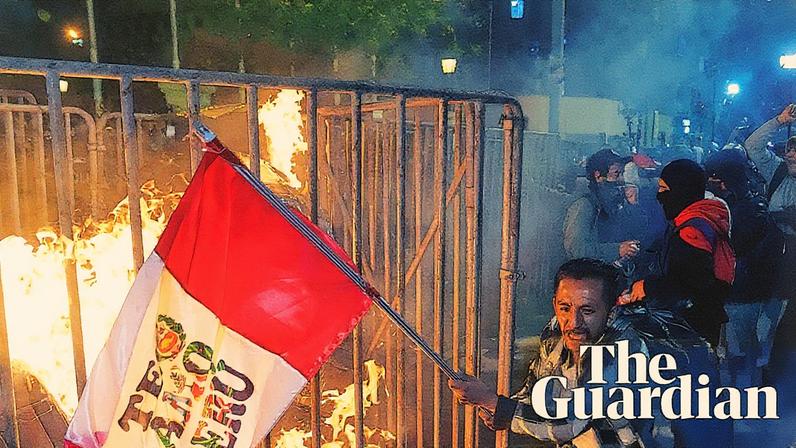 A demonstrator waves a Peruvian flag as a cardboard doll burns in front of the congress in Lima, Peru, during a protest against newly installed president José Jerí. Photograph: Martín Mejía/AP