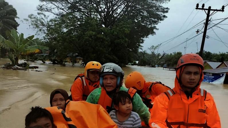 Rescuers evacuating residents from a flood-affected area in Langkat, North Sumatra province, Indonesia, on Friday.