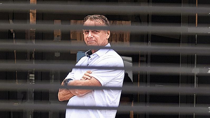 Former president Jair Bolsonaro stands at the entrance of his home, where he is currently under house arrest in Brasília, Brazil, in September. Photograph: Luis Nova/AP