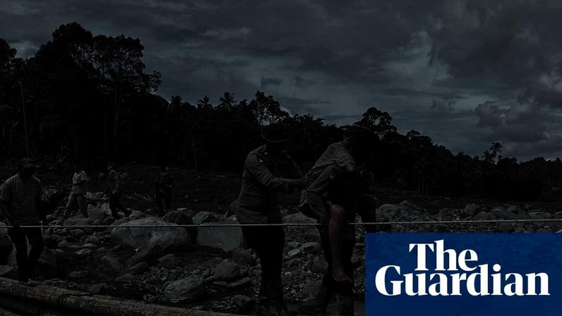 Rescuers carry a person across a makeshift bridge in an area hit by deadly landslides after heavy rains in West Sumatra, Indonesia. Photograph: Reuters