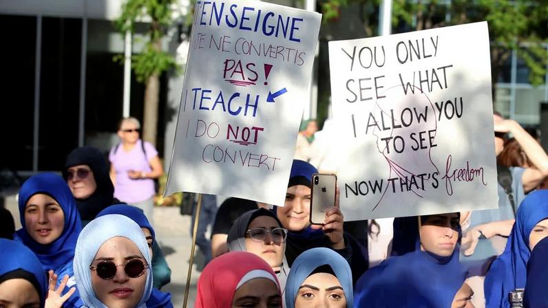 Women protested Quebec's Bill 21, which was later passed and banned teachers, police, government lawyers and others in positions of authority from wearing religious symbols and head coverings in Quebec, Canada, 17 June 2019.