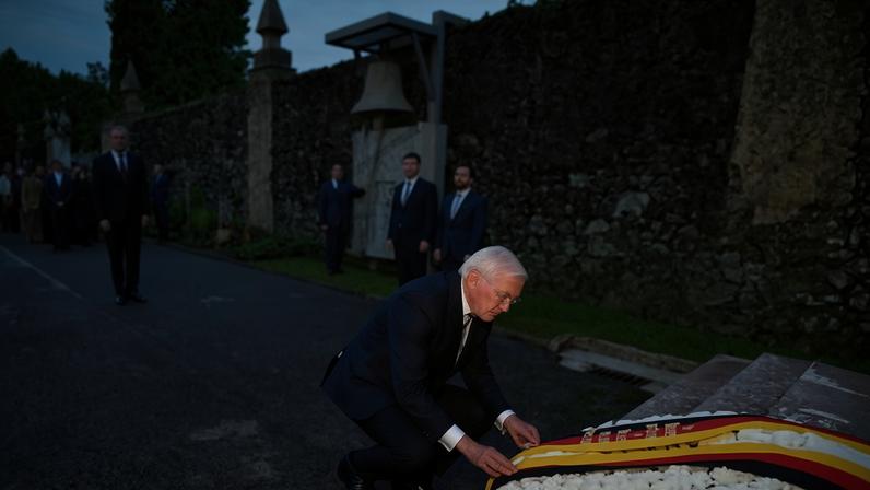 The German president, Frank-Walter Steinmeier, adjusts a ribbon with the colours of the German flag on a flower wreath in Guernica as he attends a tribute to the victims of the Nazi bombing during the Spanish civil war. Photograph: Basque Country Government/Reuters