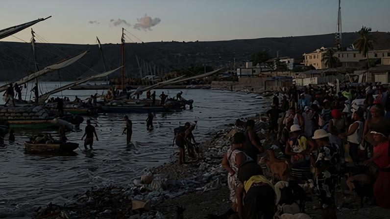 Workers unload cargo and animals from boats to the shore in Saint-Marc, Haiti on 10 Oct. 2024.