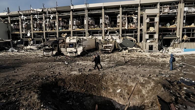 Police officers walk near a crater in front of a Novus logistics center damaged after a Russian strike on Kyiv, Ukraine, on 25 November 2025. Photograph: Evgeniy Maloletka/AP