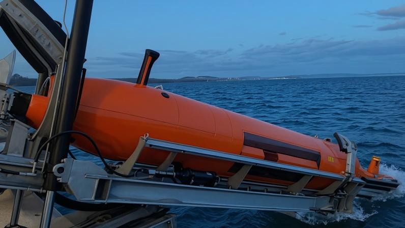 The launch of a Hugin underwater robot. It can search at depths of 6,000 metres, collecting data with echo sounders, cameras, lasers and sonar to map the seabed.