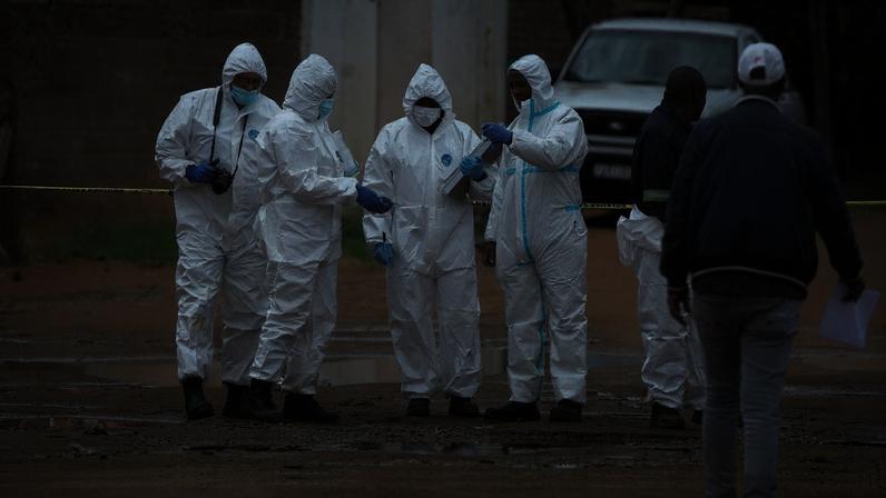 Forensic officials work at the scene of an early morning shooting in Bekkersdal township, south-west of Johannesburg, South Africa December 21, 2025. REUTERS/Siphiwe Sibeko TPX IMAGES OF THE DAY