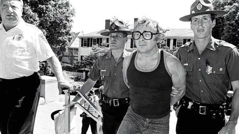 Myles Connor with police officers after being arrested in July 1985 AP Photo/Jim MacMillan