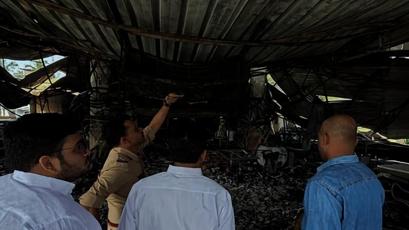 Police officials investigate the burned-out interior of Birch by Romeo Lane, the site of the Goa nightclub fire.