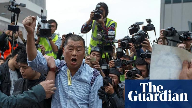 Apple Daily newspaper owner Jimmy Lai shouts to fellow pro-democracy supporters before being taken away by police outside the government headquarters in Hong Kong, December 2014.