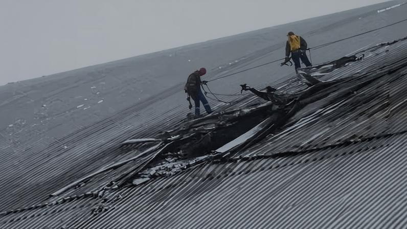 Rescuers work on the ‘new safe confinement’ covering the remains of the destroyed reactor at the Chornobyl nuclear power plant site in February.
