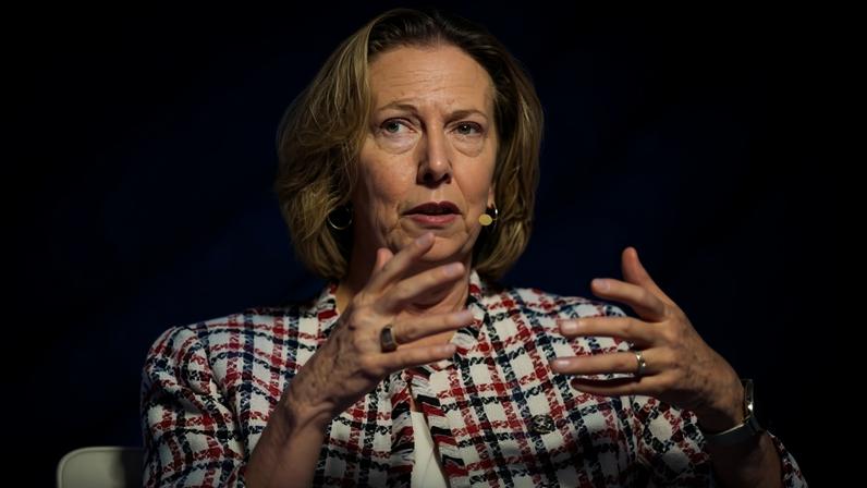 Meg O'Neill speaking at a conference