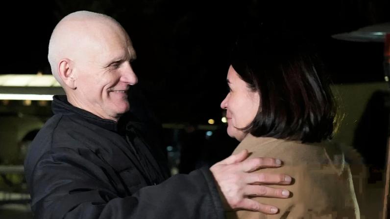 Belarusian opposition leader Sviatlana Tsikhanouskaya welcomes released prisoner Ales Bialatski as he arrives at the US embassy in Vilnius, Lithuania, on Saturday 13 December.