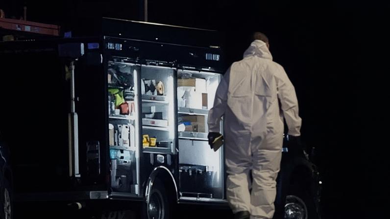An investigator works the scene at a storage facility where the alleged Brown University shooter took his own life, in Salem, New Hampshire, on Thursday.
