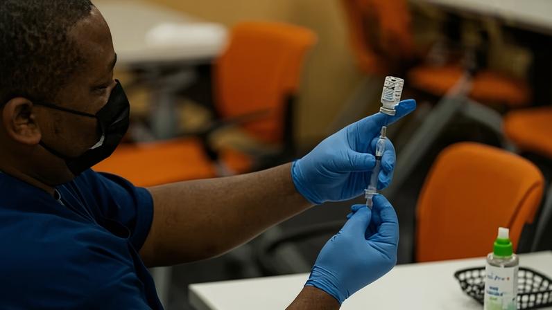 A healthcare employee prepares a syringe with the Moderna Covid-19 vaccine at the Dennis Avenue Health Center in Silver Spring, Maryland, on 21 November 2022. Photograph: The Washington Post/Getty Images