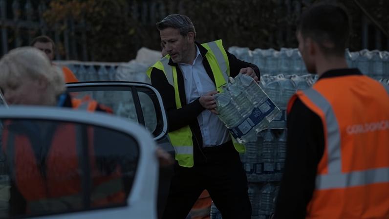 Workers hand out bottled water at Tunbridge Wells Sports Centre on Wednesday. Photograph: Gareth Fuller/PA