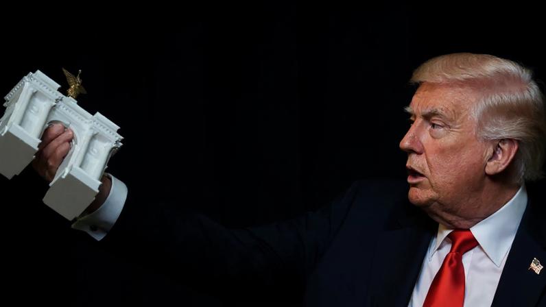 Donald Trump holds a model of an arch during a ballroom dinner at the White House in Washington DC on 15 October. Photograph: Jonathan Ernst/Reuters