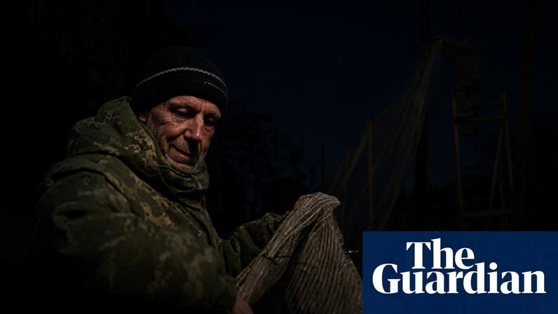 Members of the Ukranian Armed Forces install anti-drone nets in the city centre of Izyum in the Kharkiv region, about 25km west of the frontline