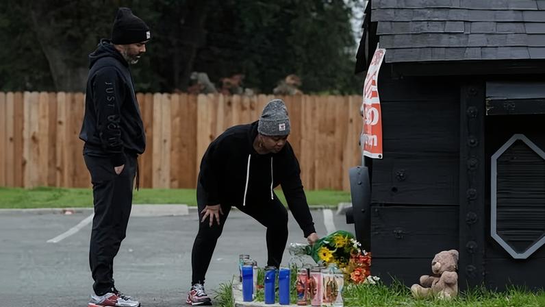 People place flowers at a memorial for the victims of the Stockton shooting.
